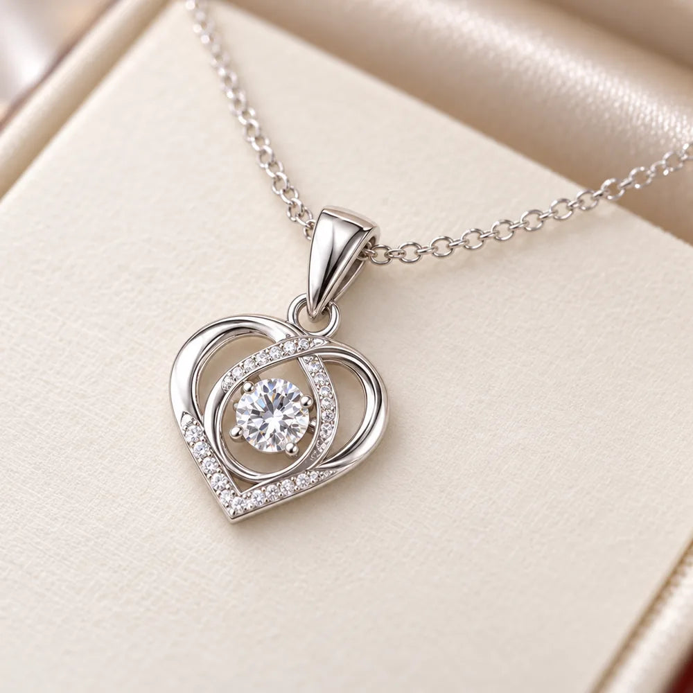 Close-up of the 14k white gold open heart pendant with a brilliant centre stone