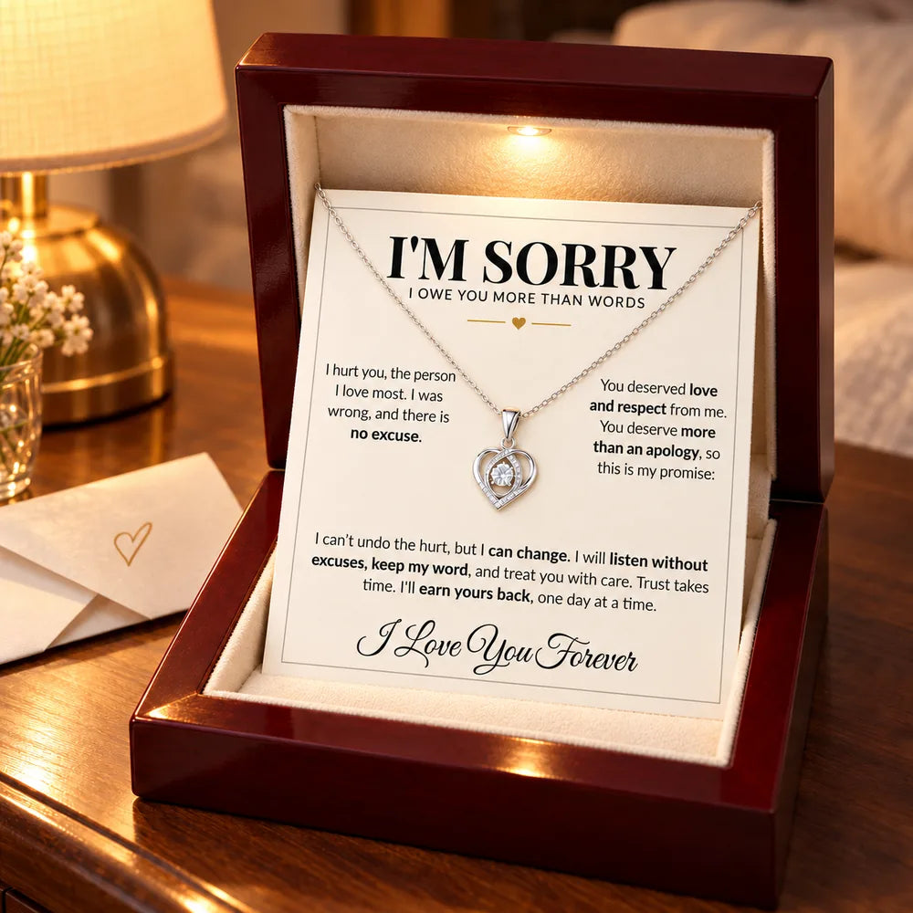 Apology necklace and "I'm Sorry" card left on a nightstand