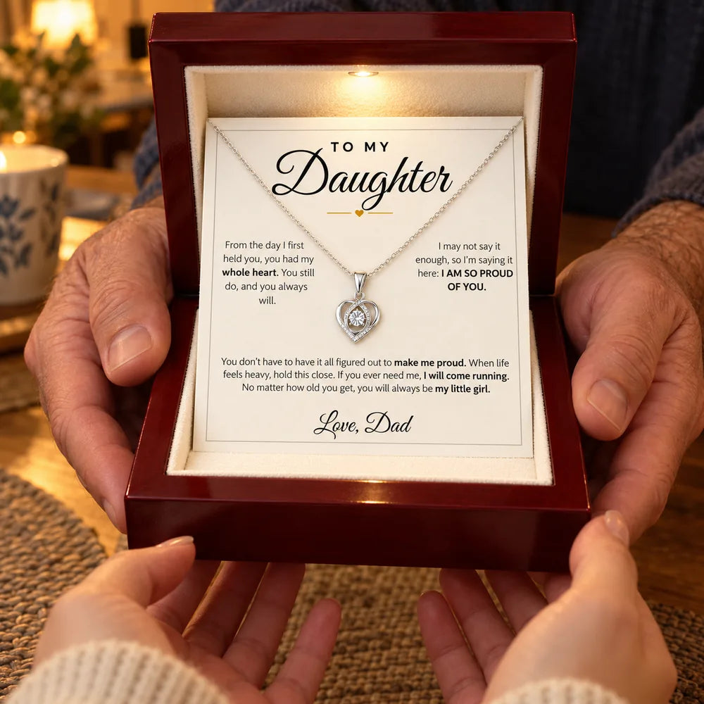 Dad giving his daughter a heart necklace gift box